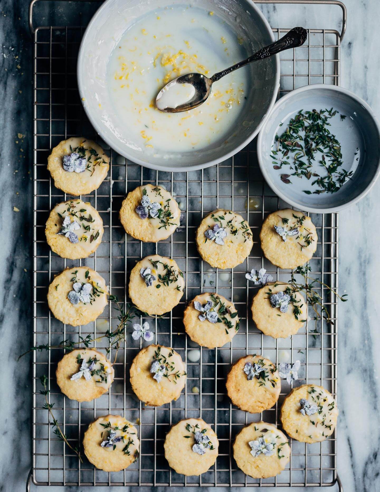 These buttery polenta cookies with a lemony cookie icing, fresh thyme leaves, and candied violets capture the flavors of early spring beautifully.