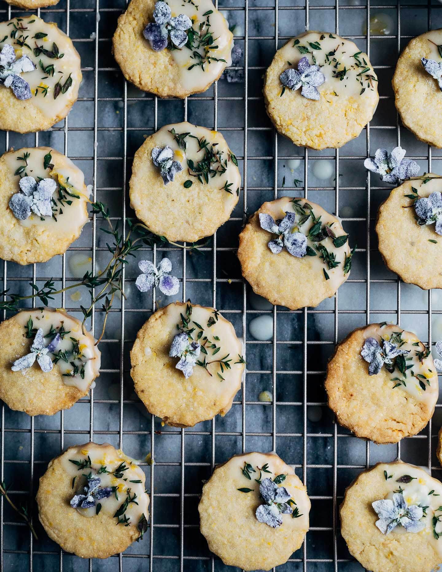 These buttery polenta cookies with a lemony cookie icing, fresh thyme leaves, and candied violets capture the flavors of early spring beautifully.