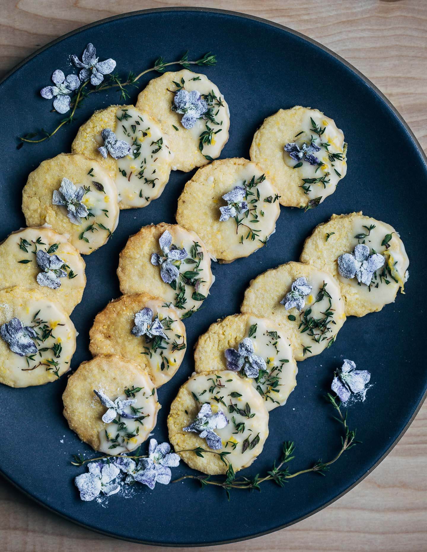 These buttery polenta cookies with a lemony cookie icing, fresh thyme leaves, and candied violets capture the flavors of early spring beautifully.