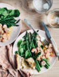 Celebrate the arrival of spring produce with this simple, super quick warm asparagus and shrimp salad topped with Meyer lemon and olive oil dressing. Add a few hunks of crusty bread and a bottle of rosé, and you have a spring feast fit for company or a languid evening outside.