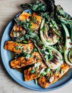 A platter with grilled bok choy and salmon.