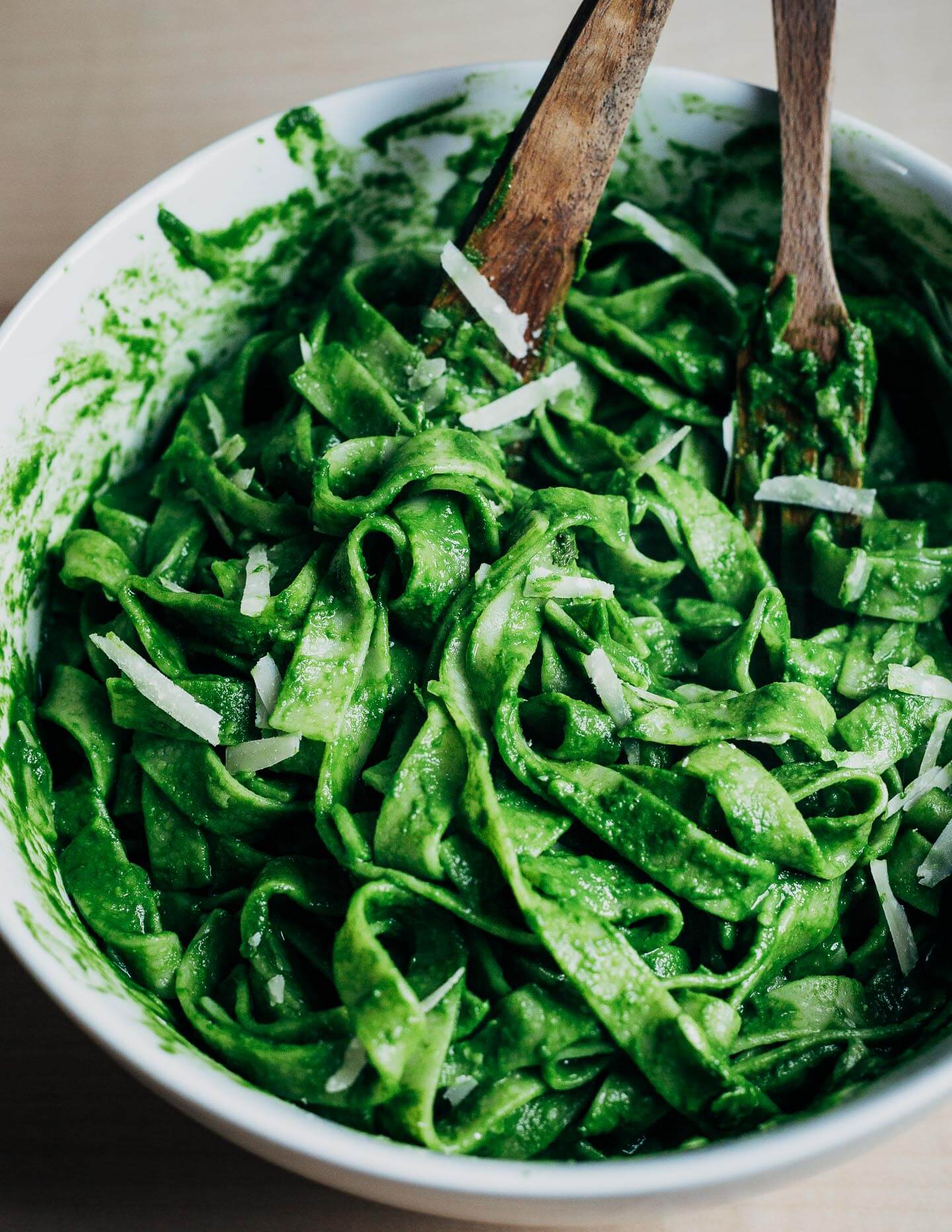 A bowl of noodles and green kale sauce.