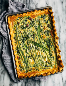 A sheet pan quiche with greens, ramps, and chives