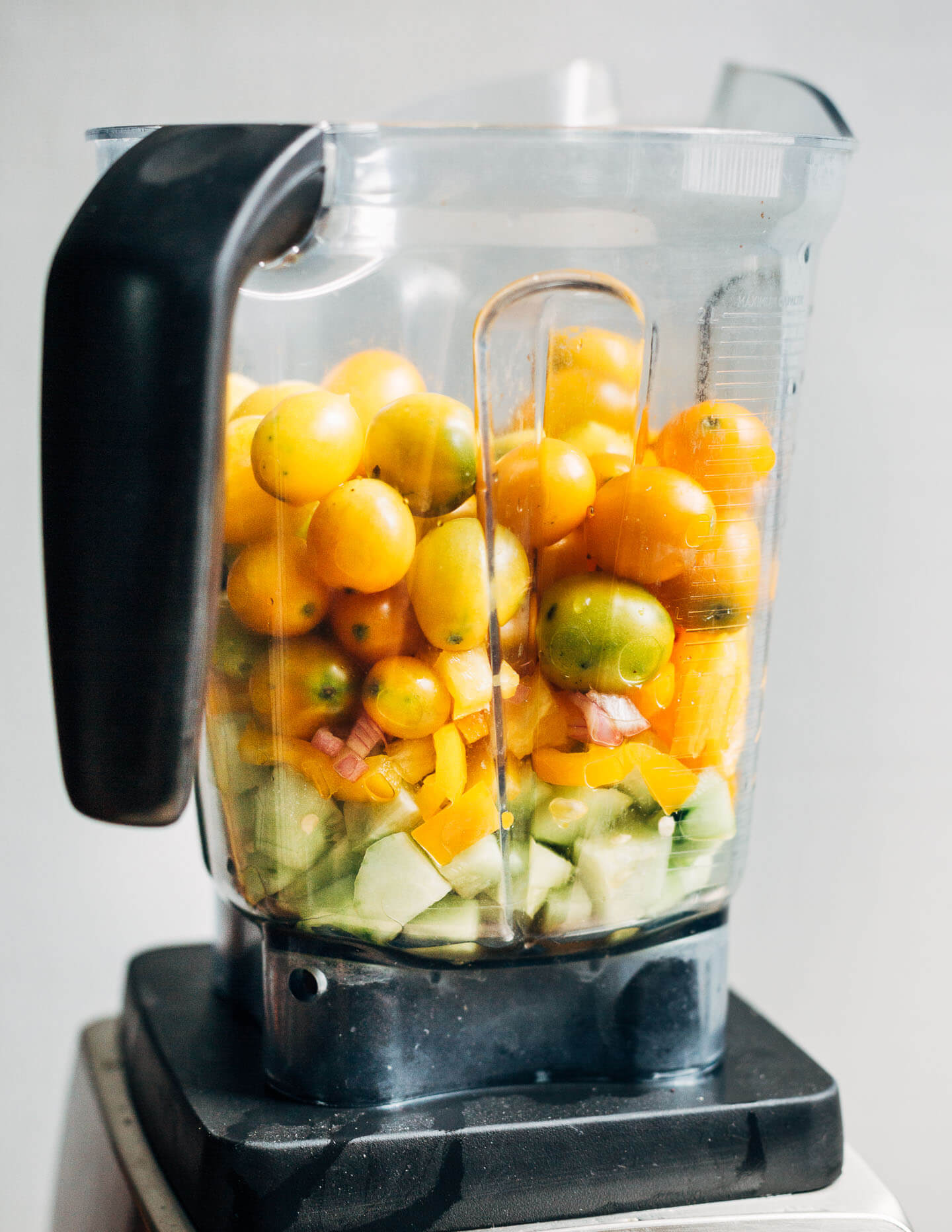 A blender filled with gazpacho ingredients