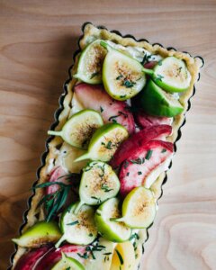 A rectangular tart with fresh figs and sliced Blood Peaches.