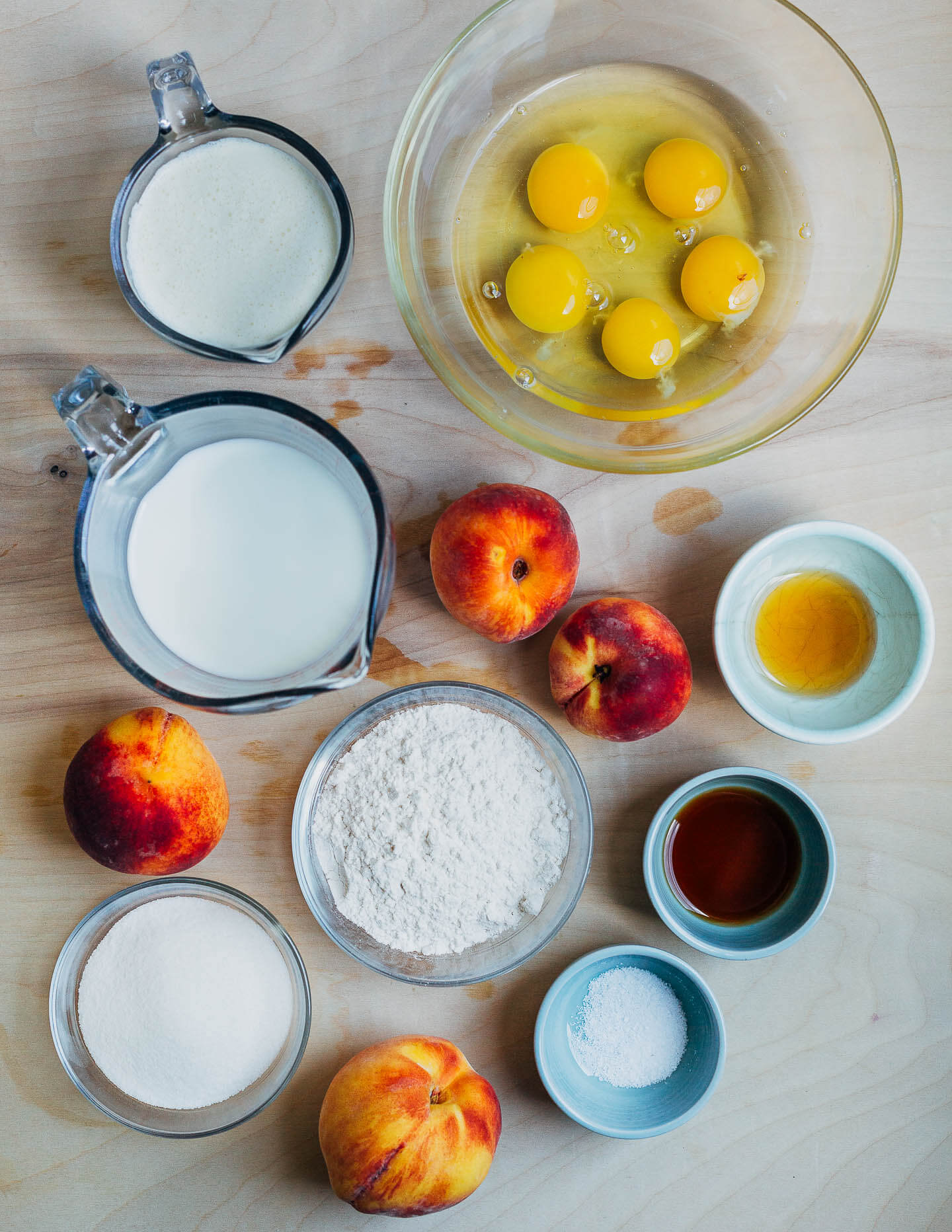 Ingredients for a custard cake, including eggs, flour, and sugar.