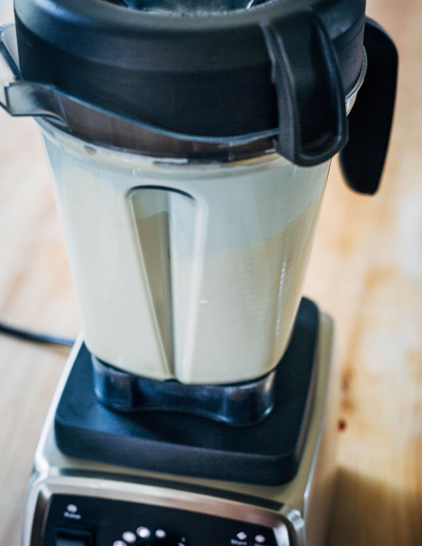 A blender with cake batter inside. 