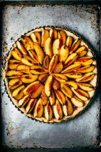 Looking down on a nectarine tart with concentric wedges.