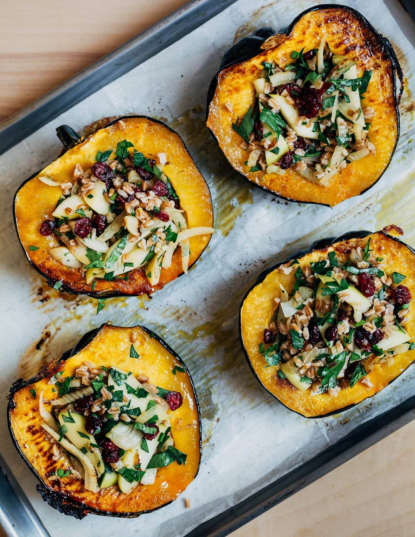 Stuffed acorn squash on a baking sheet. 