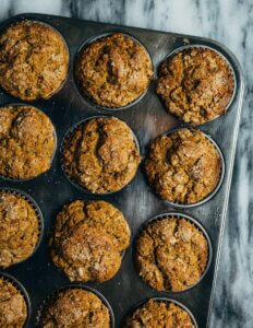 A muffin tin with just-baked butternut squash muffins.