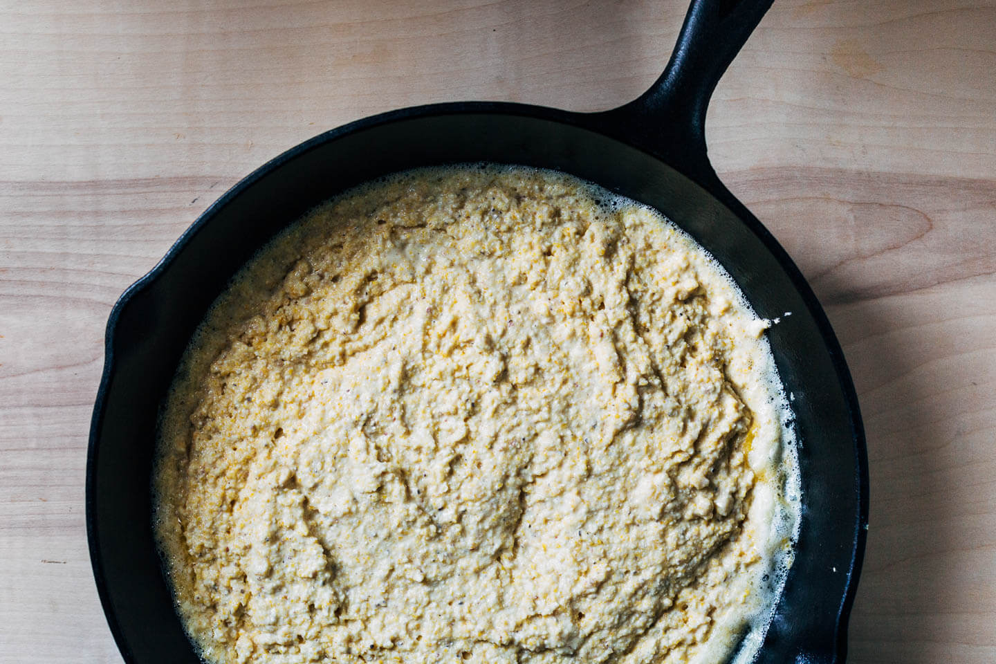 A skillet with cornbread batter.