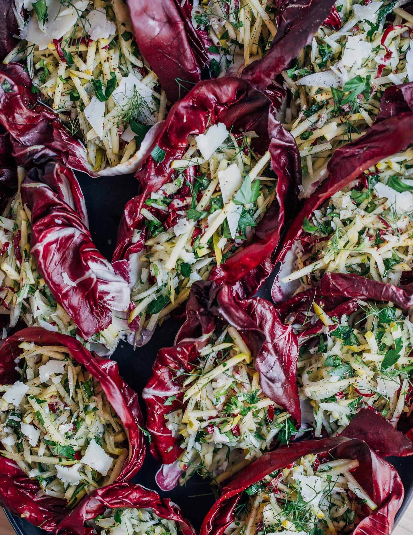 A platter with colorful salad cups made with radicchio, apple, and fennel. 