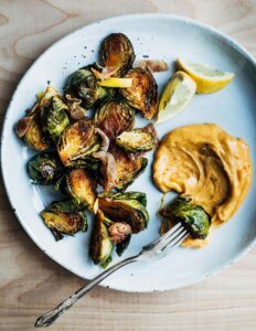 A plate of roasted Brussels sprouts with aioli.