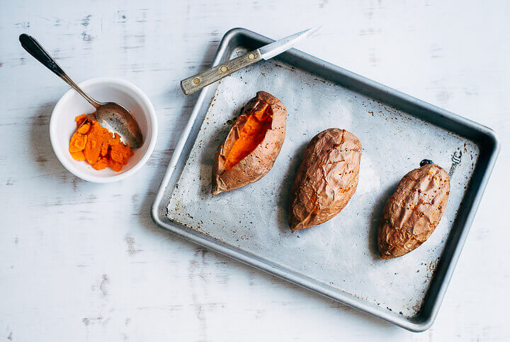 A sheet pan with roasted sweet potatoes. 