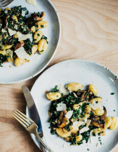 Two paltes with gnocchi and greens.