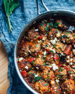 A skillet with meatballs in a tomato sauce