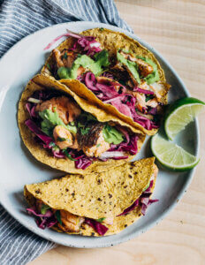 A plate of salmon tacos with red cabbage