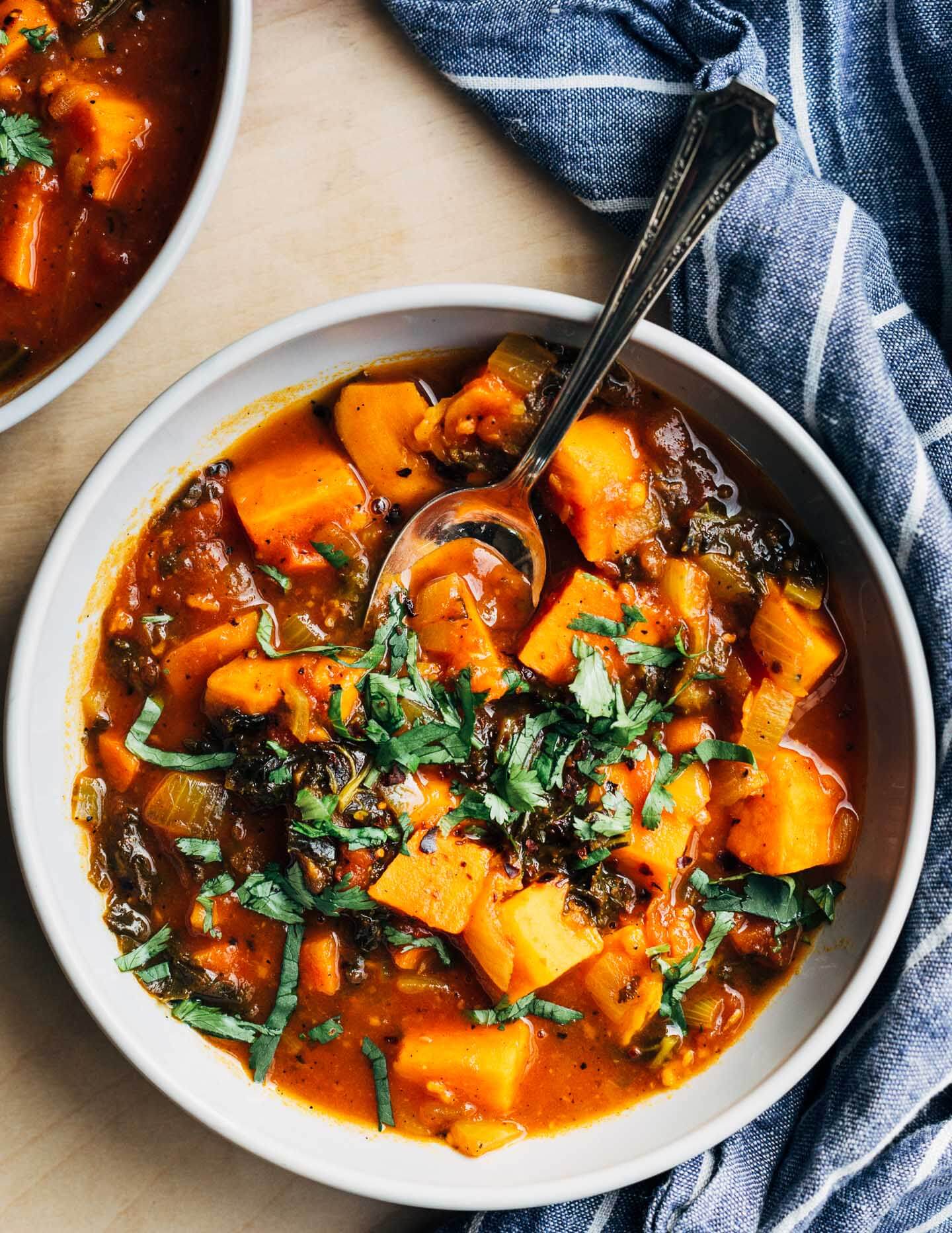 A bowl of stew with fresh cilantro on top. 