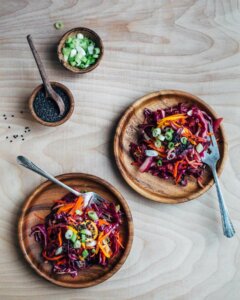 Wooden bowls with a red cabbage salad.