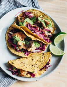 Salmon and cabbage tacos on a plate.