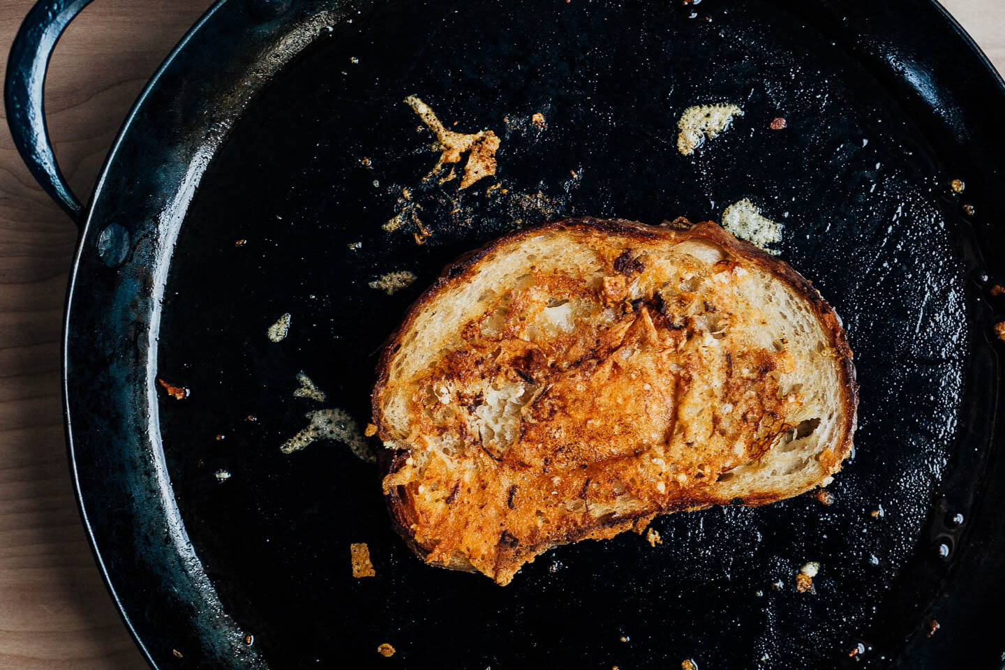 Grilled cheese cooking in a skillet. 