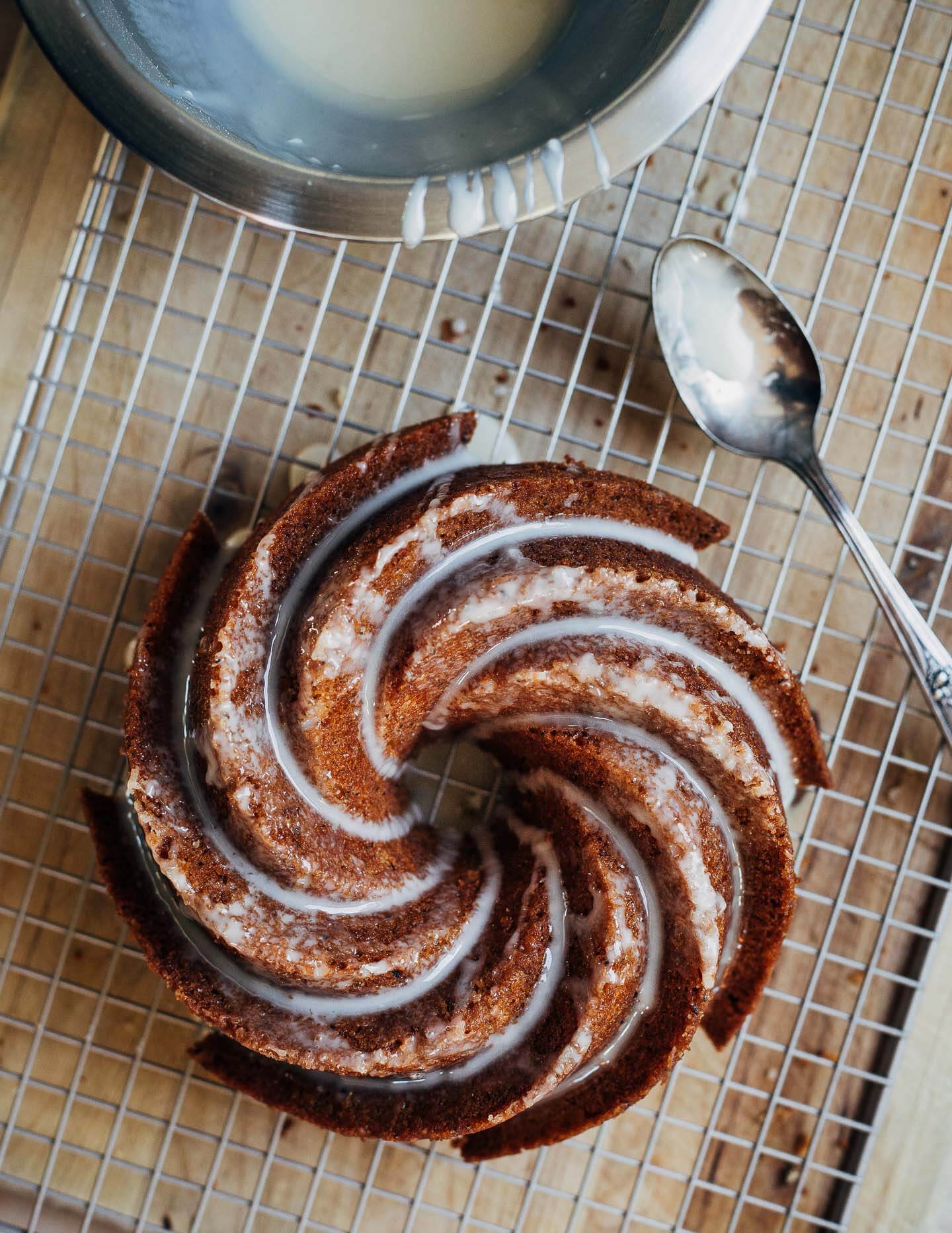 A bundt cake on a rack, drizzled with the glaze. 