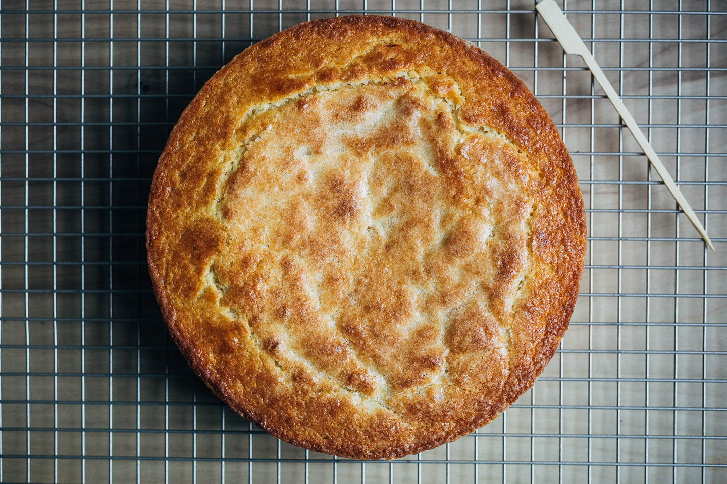 A cake cooling on a wire rack.