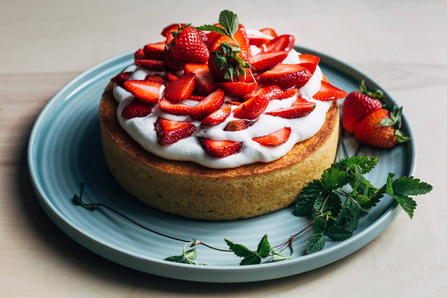 A cake topped with whipped cream and strawberries. 