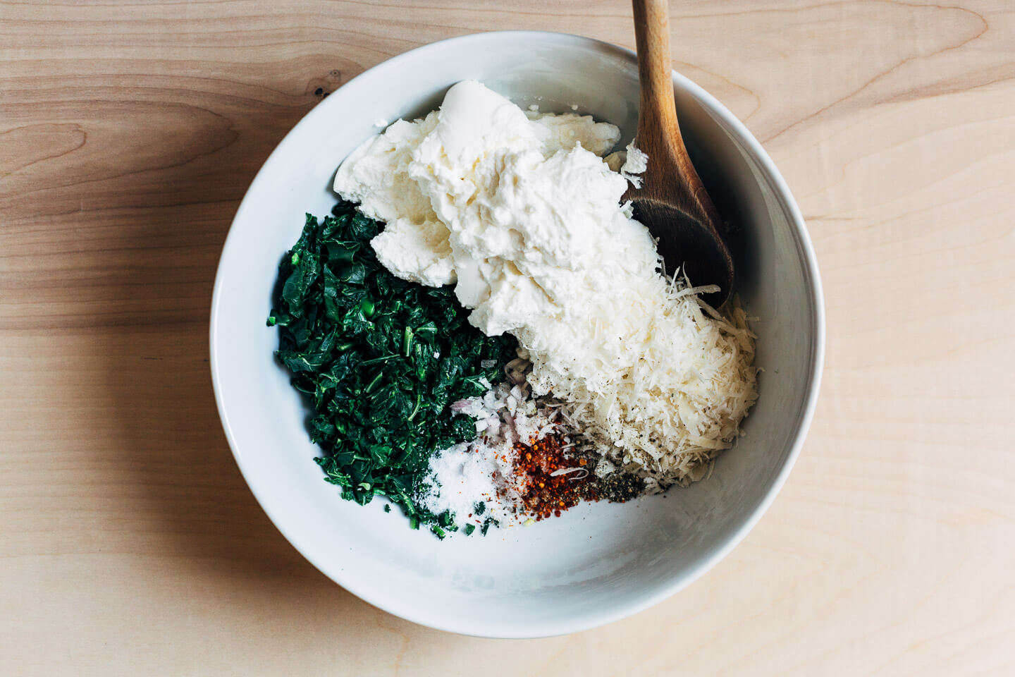 A bowl with ingredients for the stuffed shells filling. 