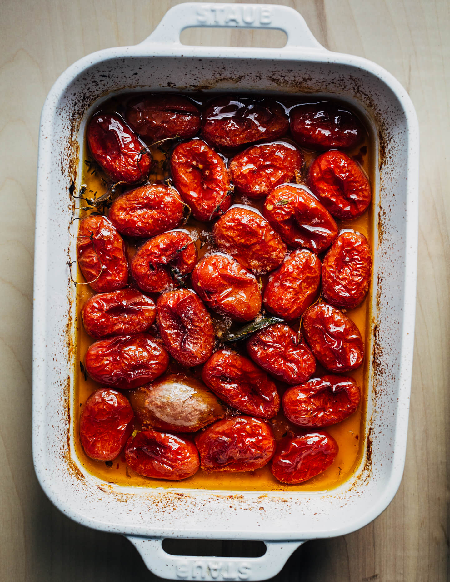 A baking dish with cooked plum tomato confit. 