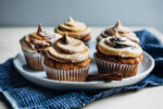 Lofty pumpkin cupcakes with brown sugar and molasses-swirled cream cheese frosting are the perfect fall treat!