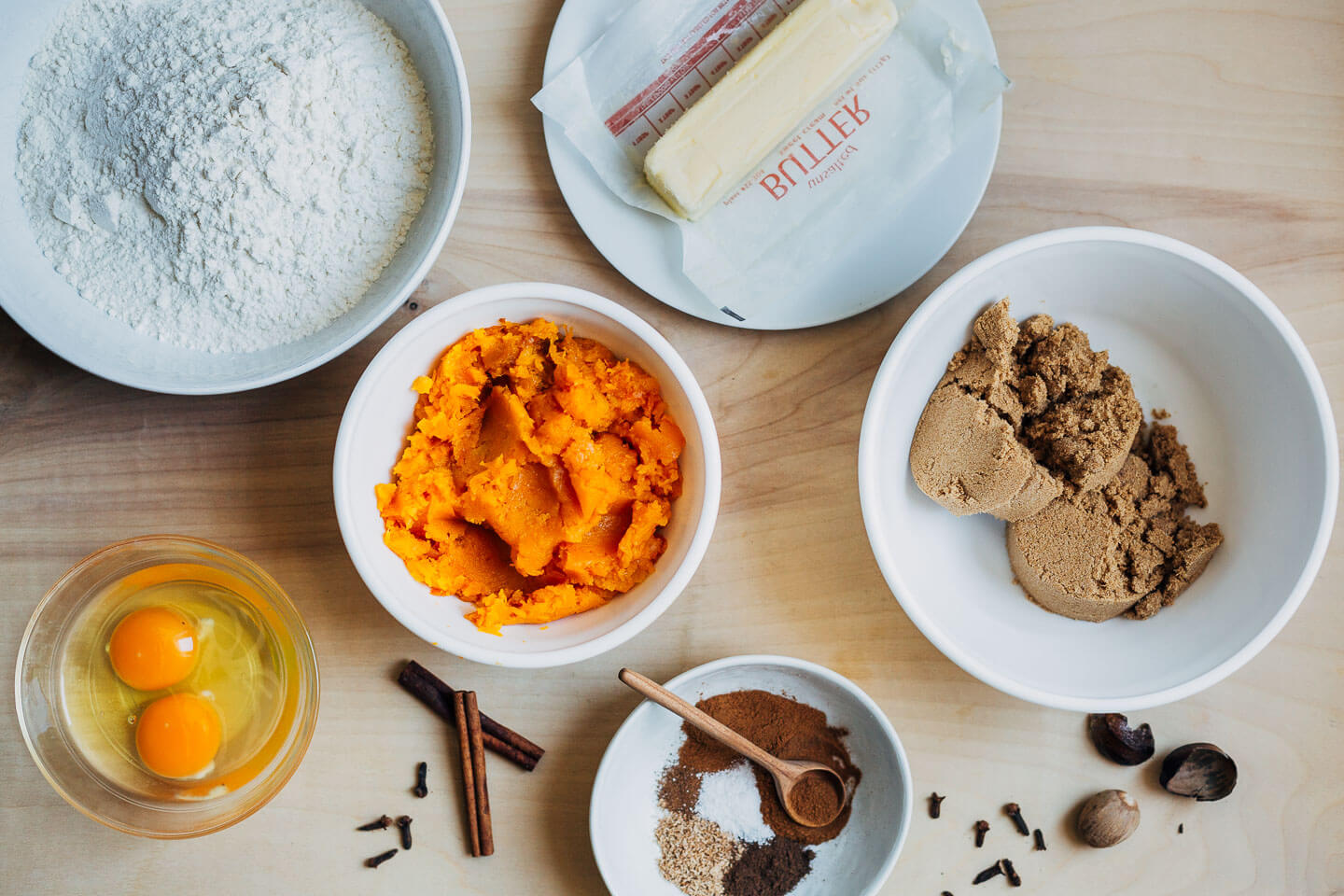 Ingredients for pumpkin cupcakes measured into bowls. 