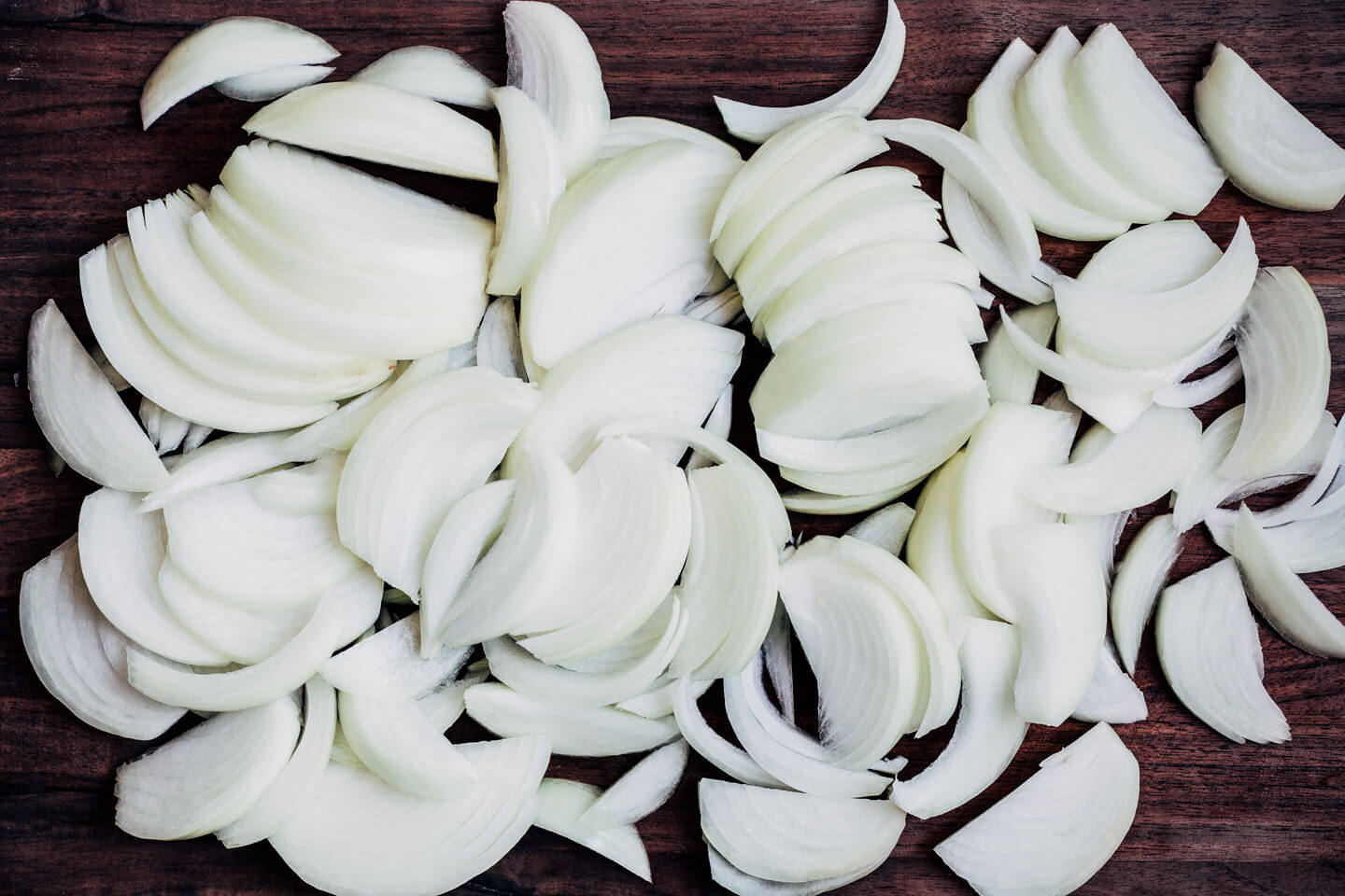 Sliced onions on a cutting board. 