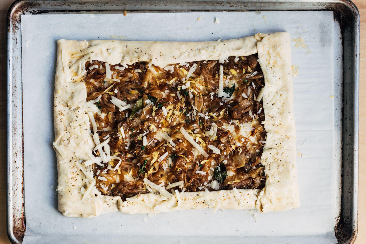 A caramelized onion tart, ready to bake.