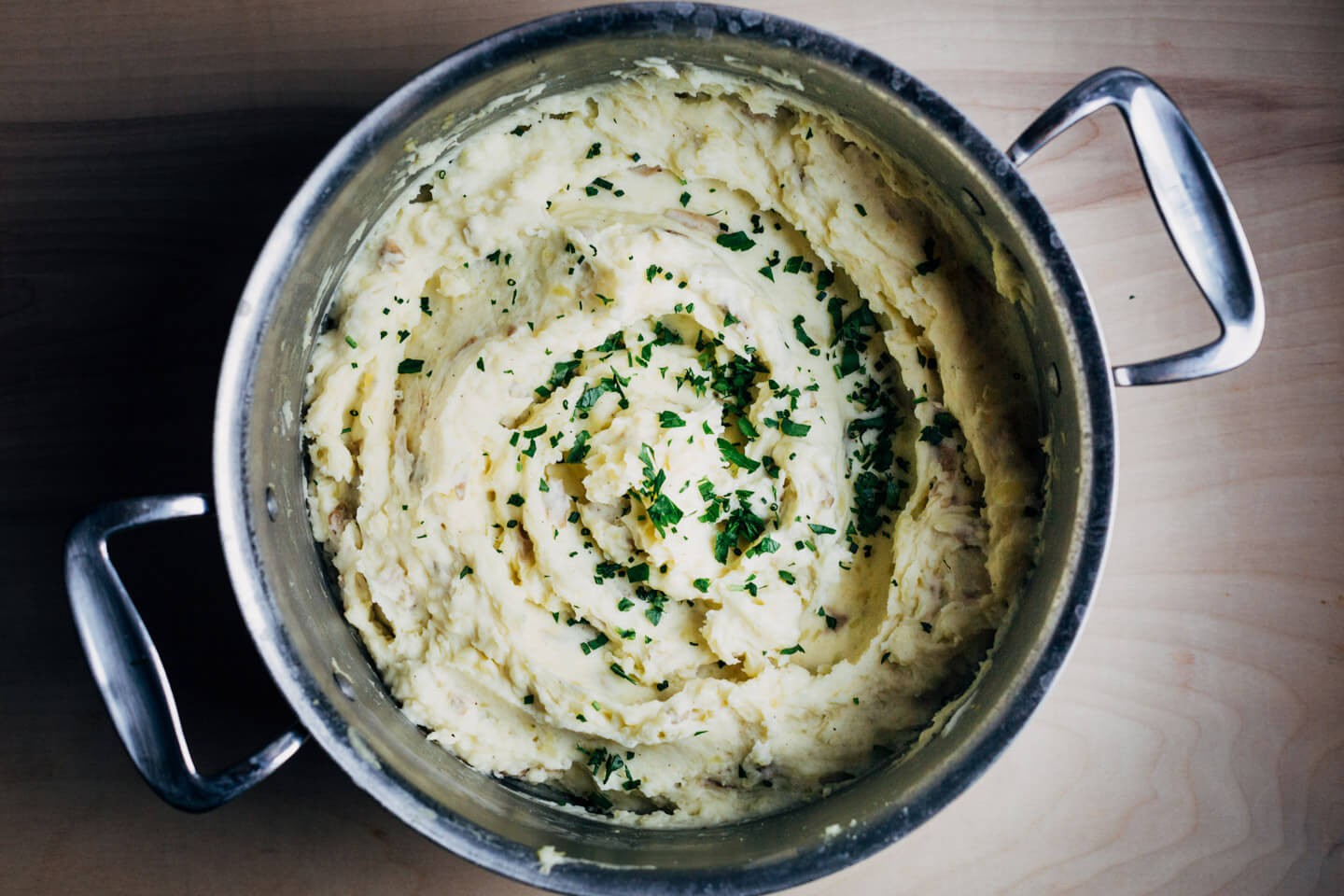 A big pot of mashed potatoes with herbs