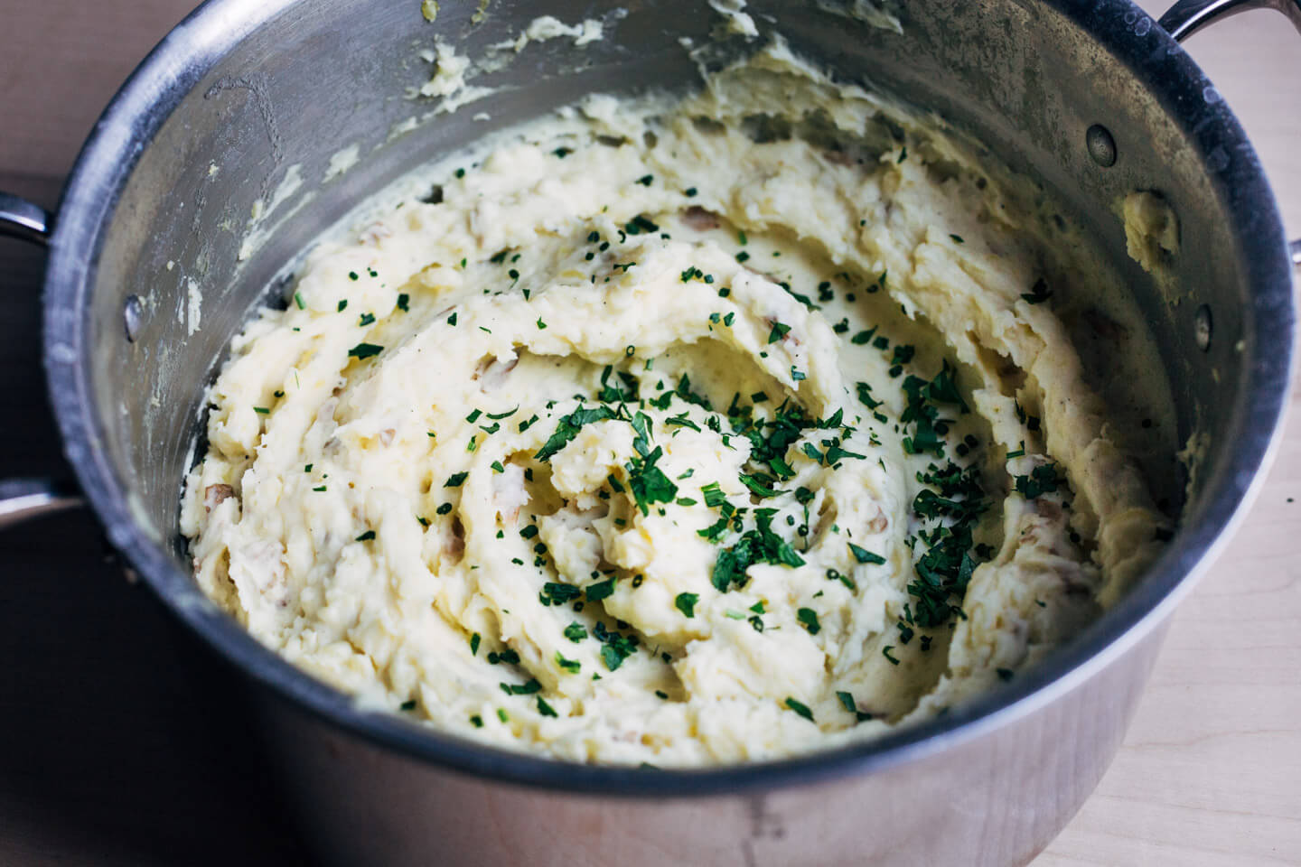 A big pot of mashed potatoes with herbs