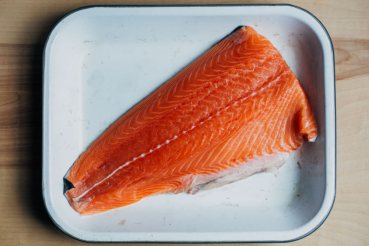 A salmon filet in a baking dish. 