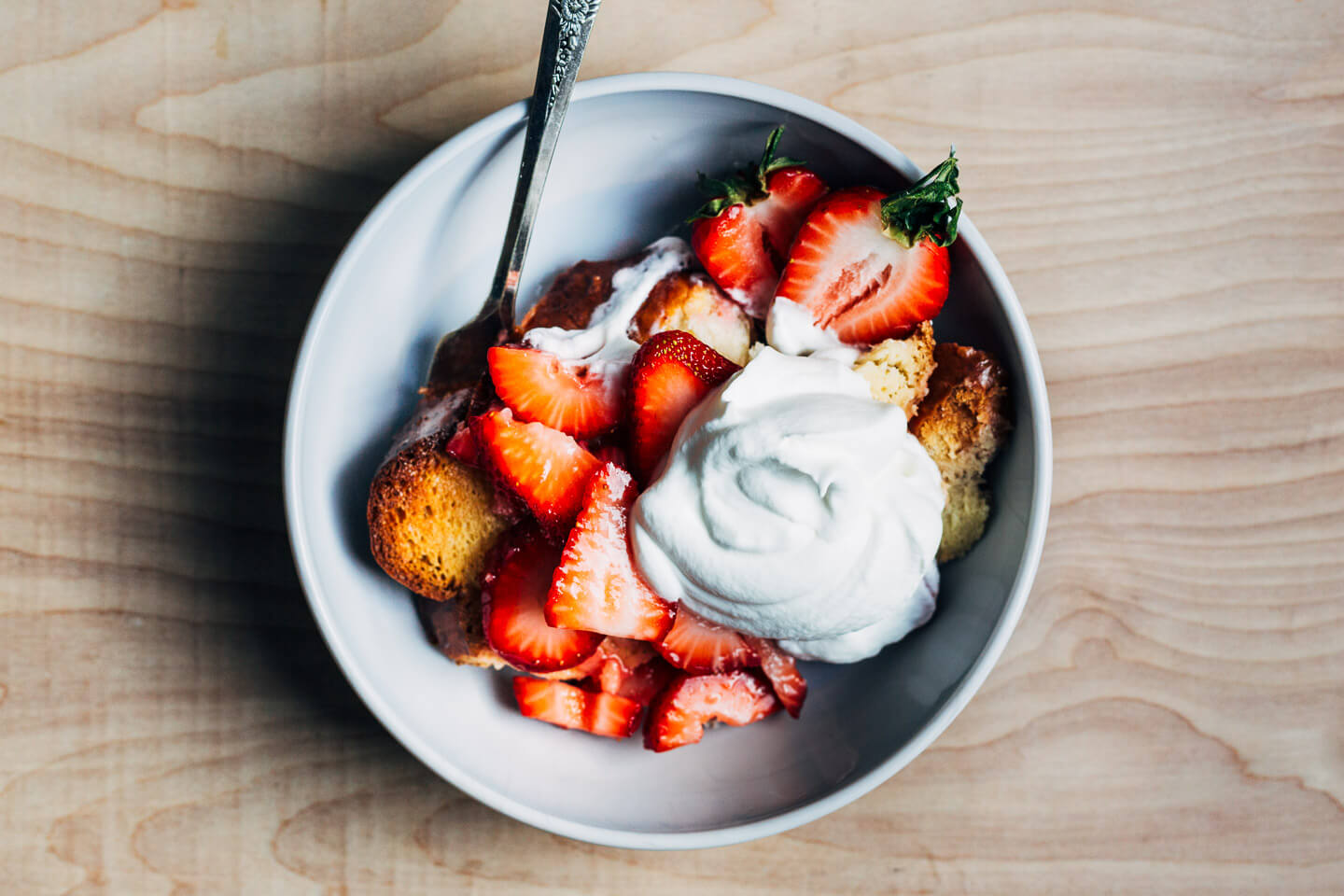 A bowl of strawberries and cream French toast