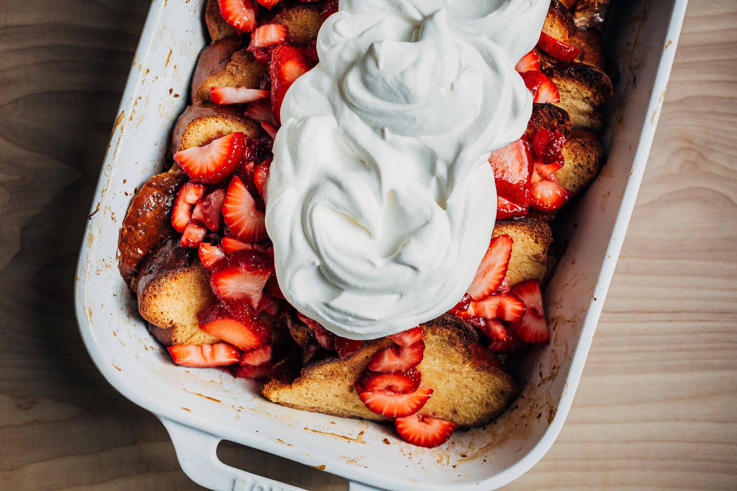 Baked French toast topped with strawberries and cream