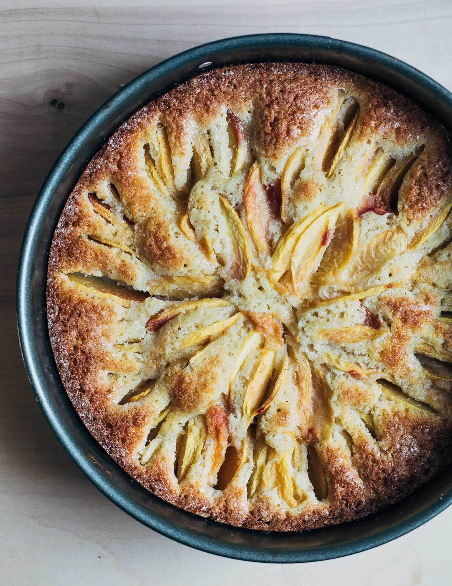 A peach-studded cornmeal cake in the baking pan. 