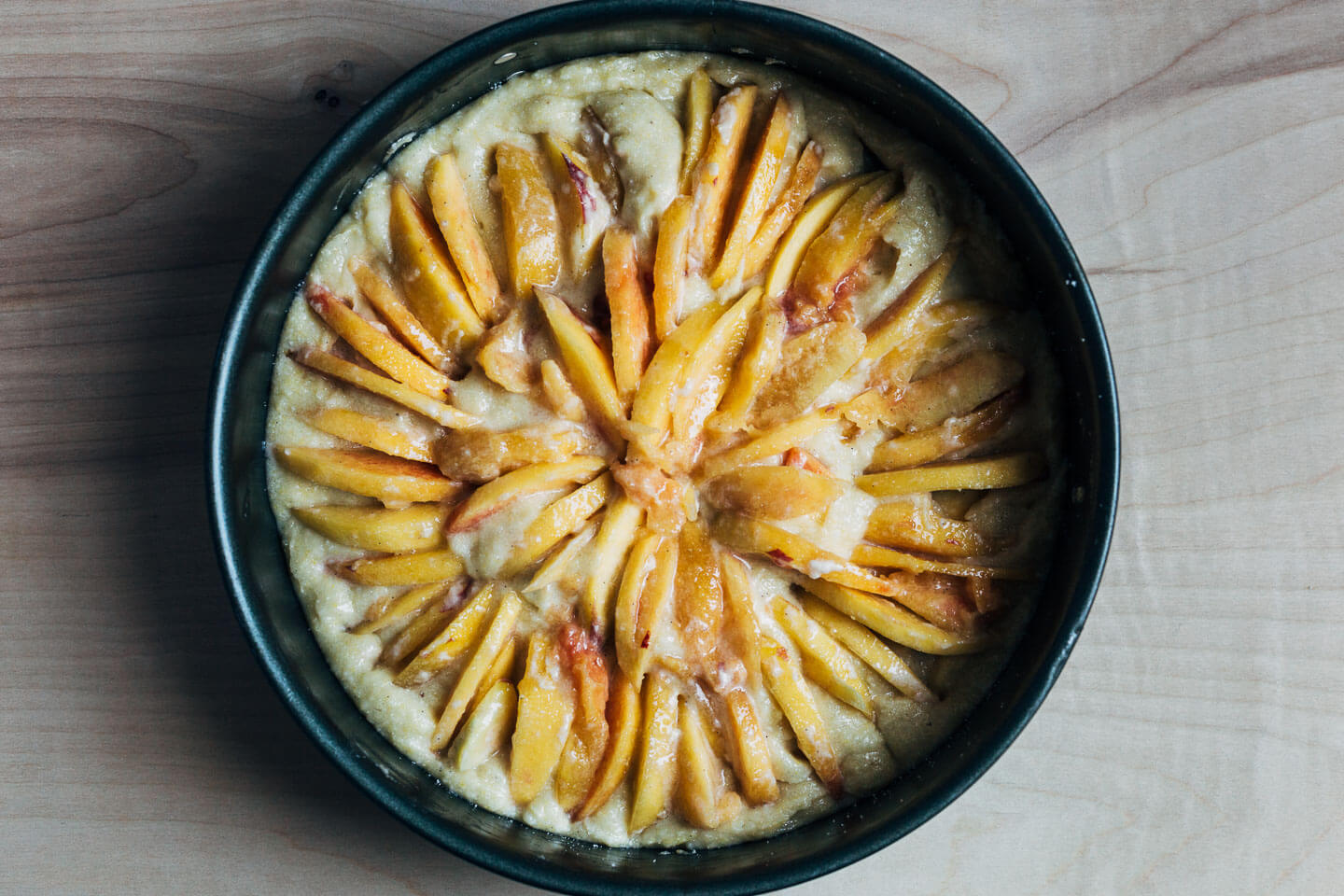 A peach cornmeal cake, ready to bake. 