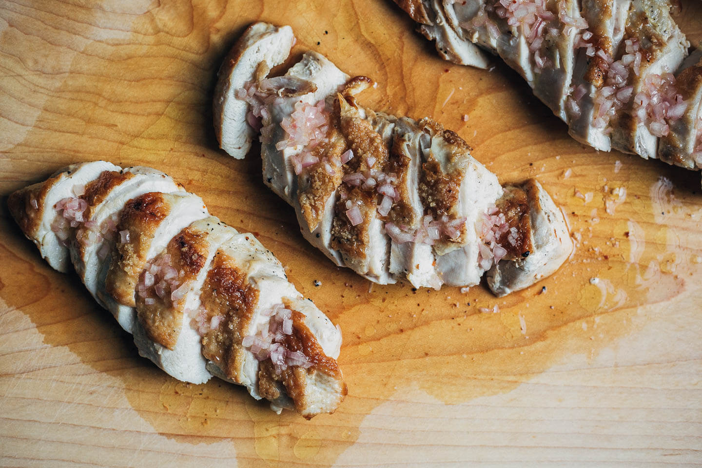 Sliced chicken on a cutting board. 